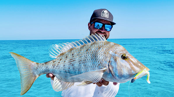 Matt Scholz on the boat holding a large spangled emperor, blue mirror lenses